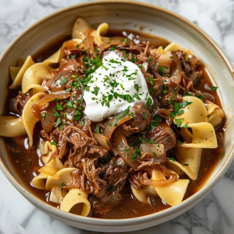 Delicious Crock Pot French Onion Beef and Noodles served in a cozy bowl.